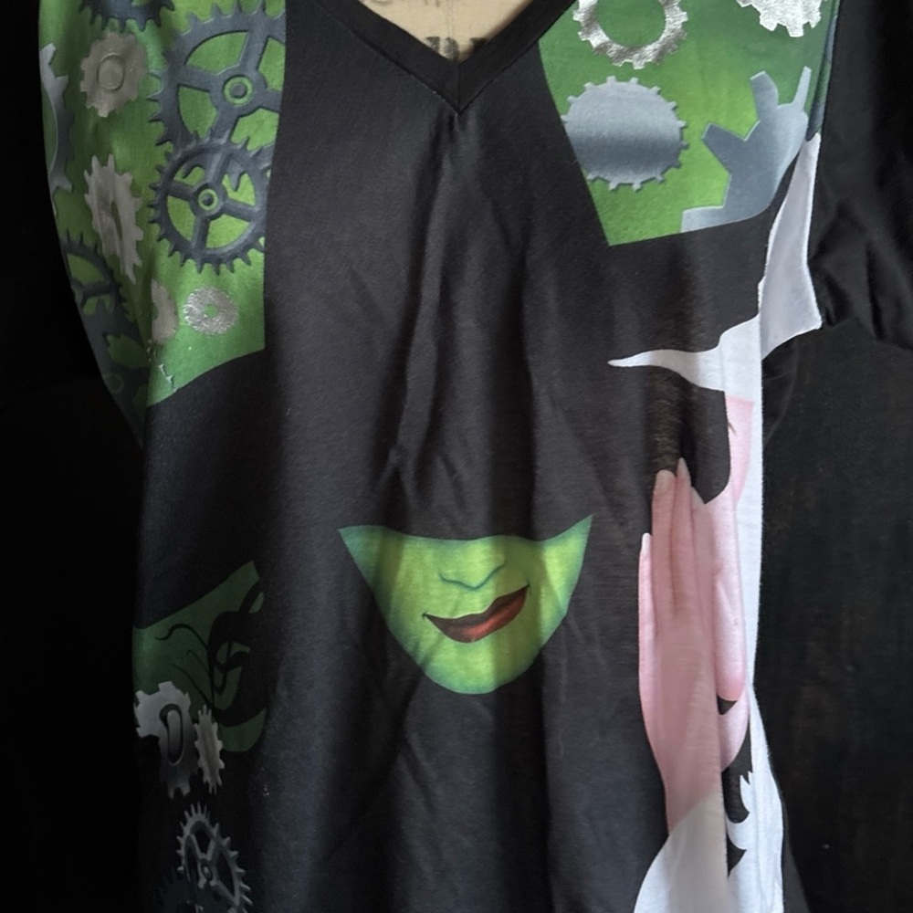 WICKED Elphaba Wear by Merch-Kin’s of OZ -Youth 4X =L Witch Faces on Black Shirt
